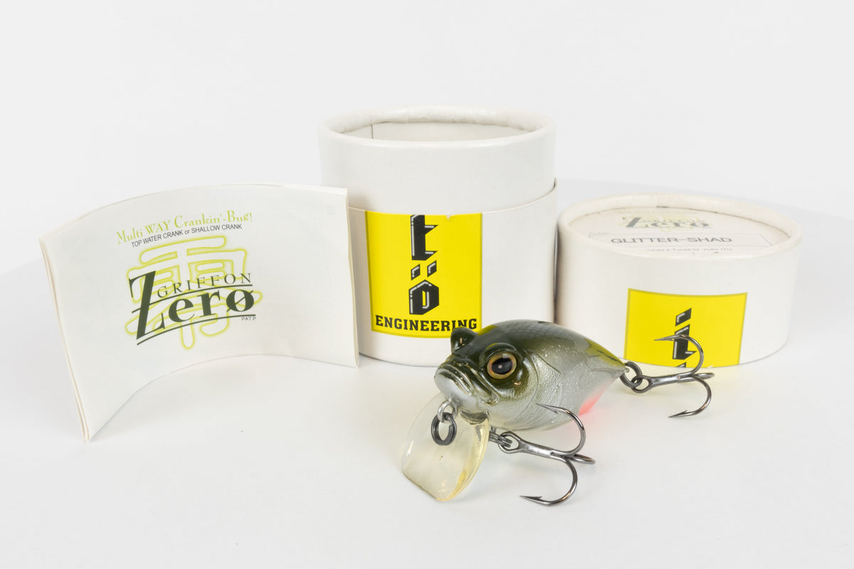 Megabass Griffon Zero - 2003 model - Glitter Shad - discontinued fishing lure new in original packaging - front view of lure and packaging box with papers. 