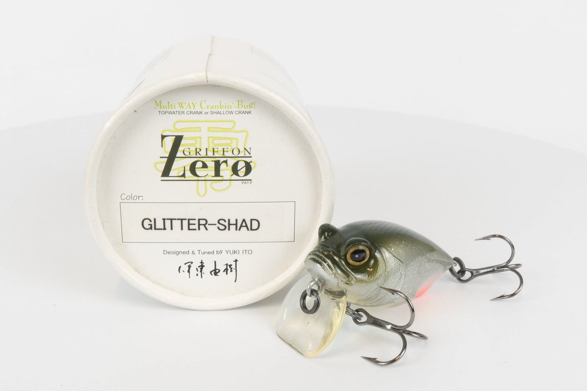 Megabass Griffon Zero - 2003 model - Glitter Shad - discontinued fishing lure new in original packaging - front view of lure and packaging box. 
