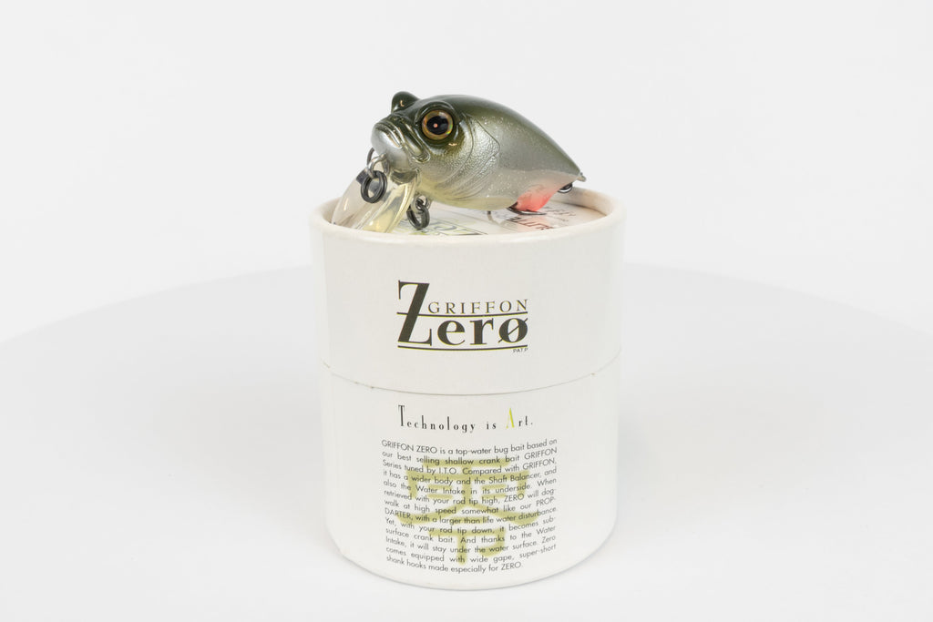 Megabass Griffon Zero - 2003 model - Glitter Shad - discontinued fishing lure new in original packaging - front view of lure and packaging box. 