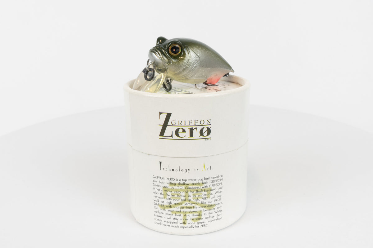Megabass Griffon Zero - 2003 model - Glitter Shad - discontinued fishing lure new in original packaging - front view of lure and packaging box. 