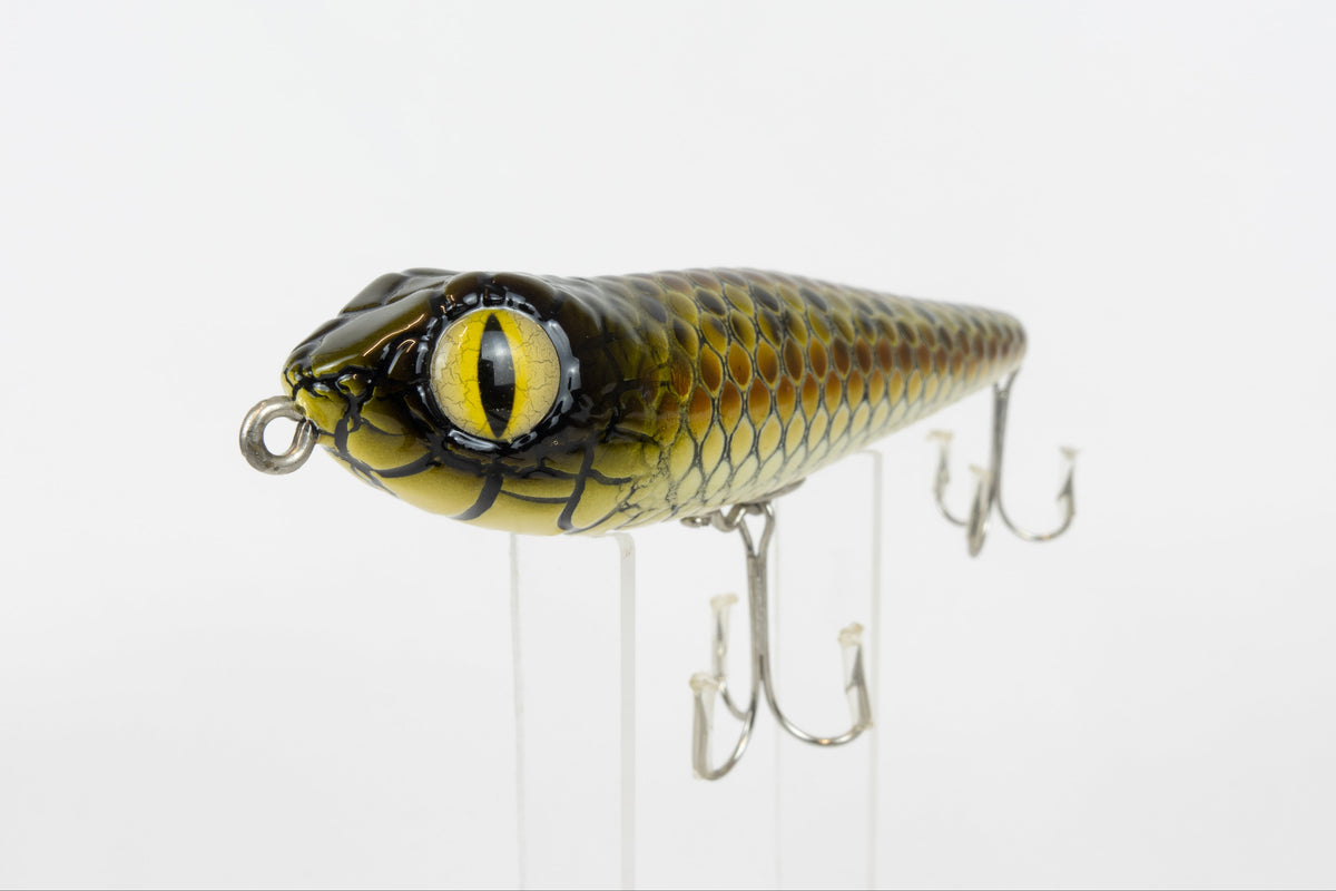 Bloodshot Raptor - Handmade Japanese Pencil Bait - Snake Skin pattern, new in original packaging, front close up view of fishing lure. 