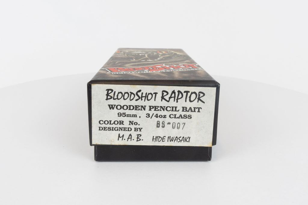 Bloodshot Raptor - Handmade Japanese Pencil Bait - Snake Skin pattern, new in original packaging, end description view of packaging box. 