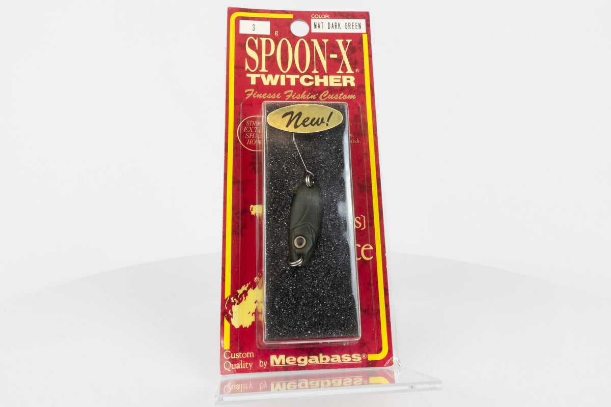 Megabass Spoon-X Twitcher - Mat Dark Green, discontinued Japanese made lure, new in original packaging, front view.
