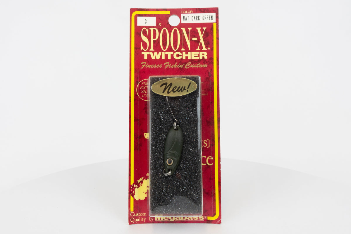 Megabass Spoon-X Twitcher - Mat Dark Green, discontinued Japanese made lure, new in original packaging, front view.