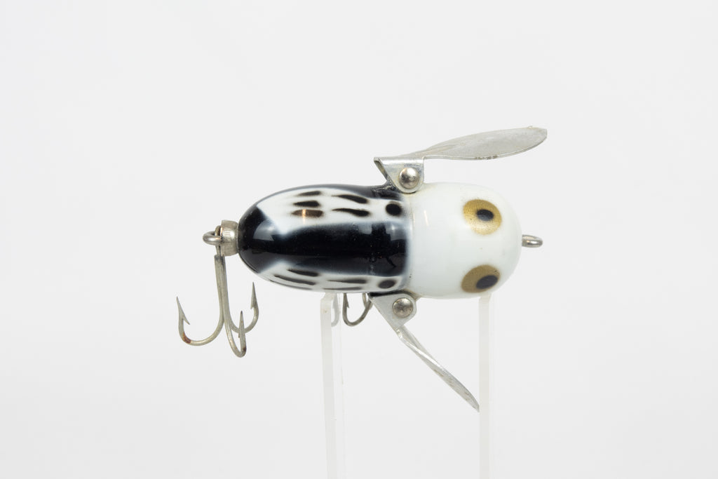 Heddon Tiny Crazy Crawler - BWH (Black, White Head) - Vintage lure in original packaging. Top view of lure on stand. 