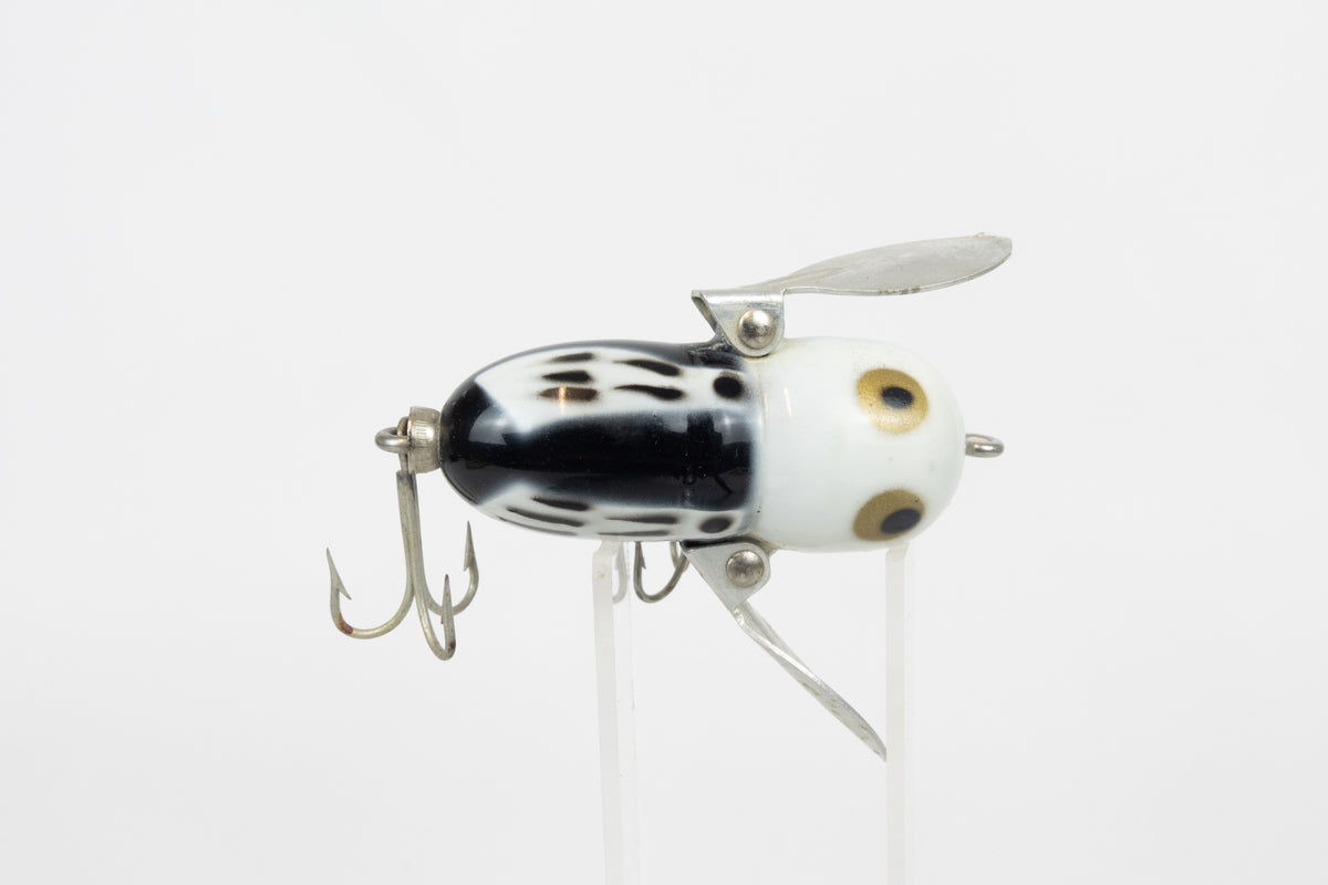 Heddon Tiny Crazy Crawler - BWH (Black, White Head) - Vintage lure in original packaging. Top view of lure on stand. 