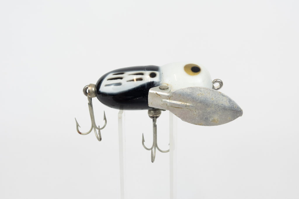 Heddon Tiny Crazy Crawler - BWH (Black, White Head) - Vintage lure in original packaging. Right side view of lure on stand. 