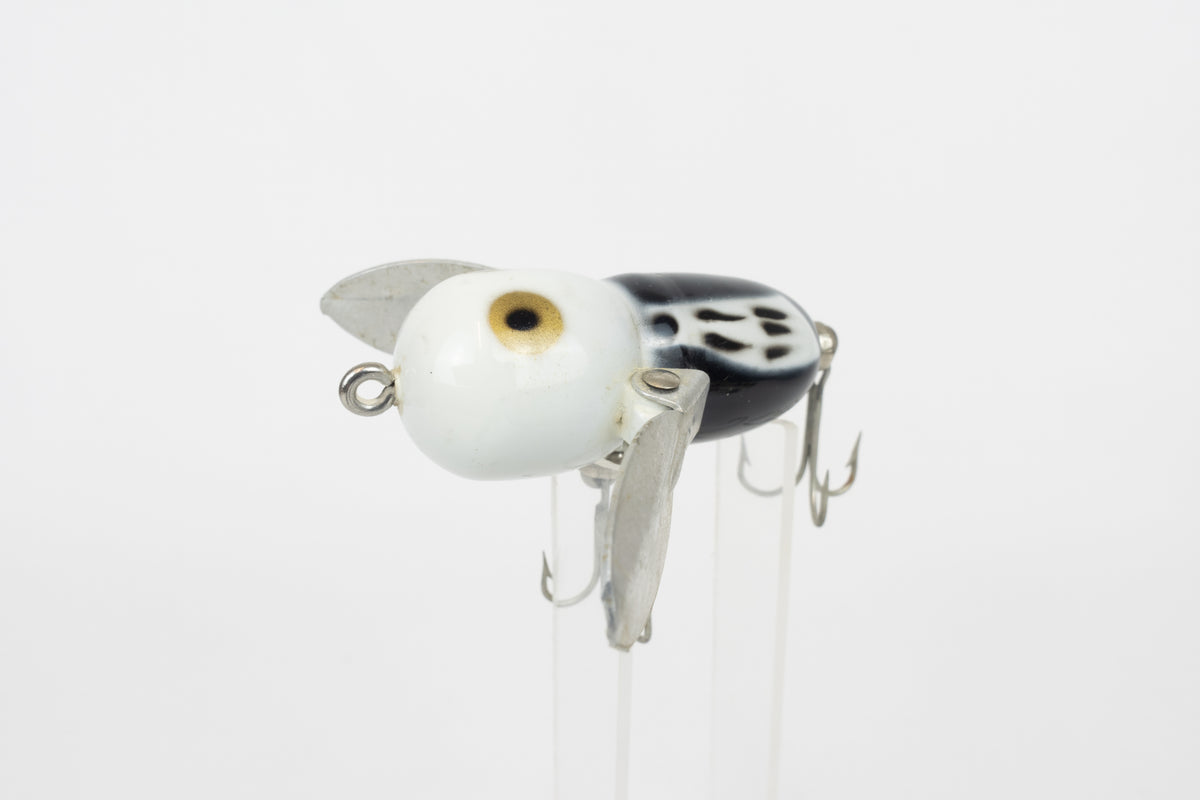 Heddon Tiny Crazy Crawler - BWH (Black, White Head) - Vintage lure in original packaging. Front view of lure on stand. 