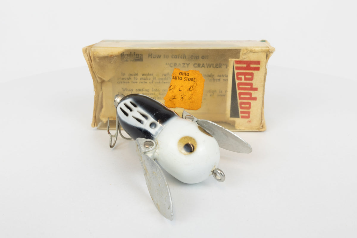 Heddon Tiny Crazy Crawler - BWH (Black, White Head) - Vintage lure in original packaging. View of lure in front of packaging. 