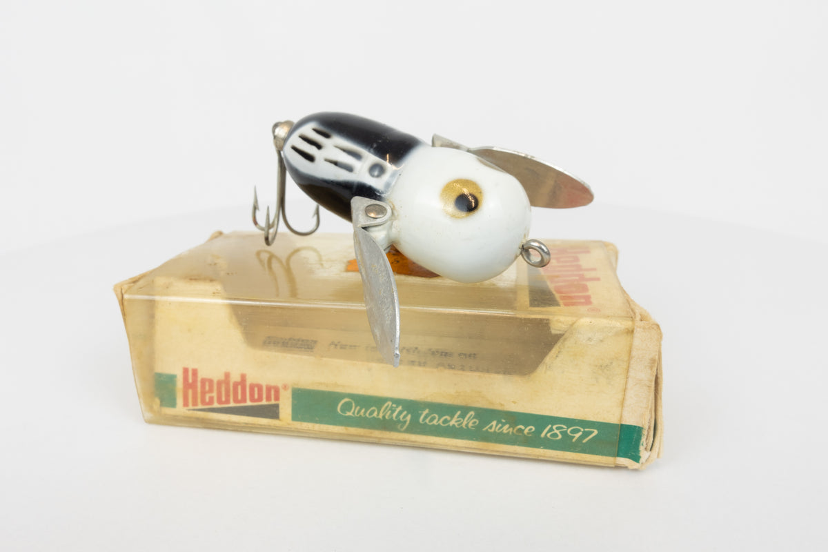 Heddon Tiny Crazy Crawler - BWH (Black, White Head) - Vintage lure in original packaging. View of lure on top of packaging. 