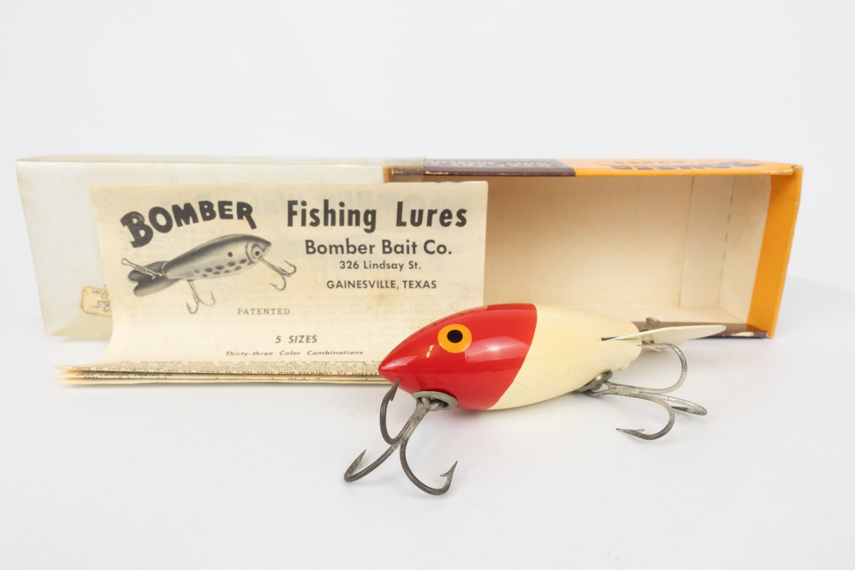 Bomber Bait Co. Bomber - vintage American fishing lure, near new condition in original packaging (aged), view of lure in front of packaging and paper insert.
