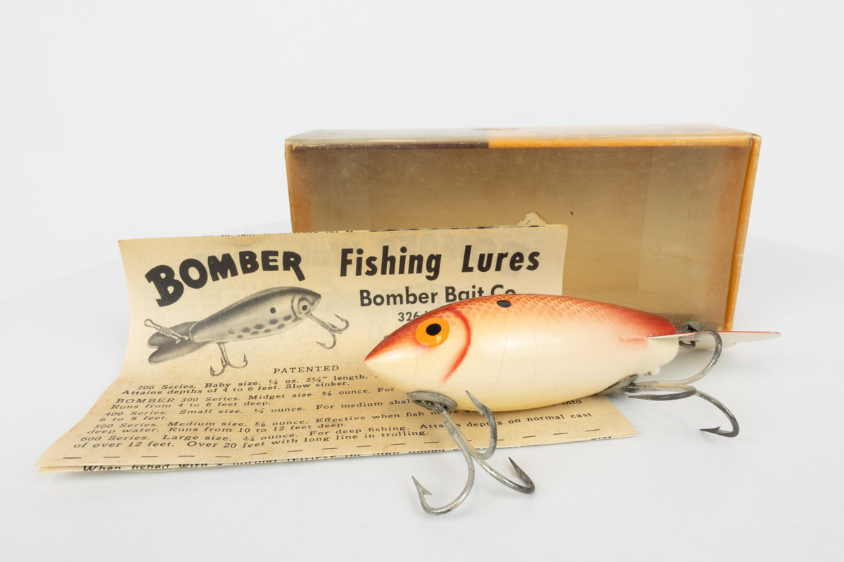 Bomber Bait Co. Bomber - vintage American fishing lure, near new condition in original packaging (aged), view of lure in front of packaging and paper insert.