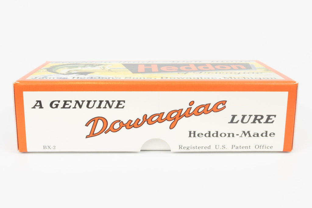 Vintage Dowagiac Heddon lure box, model BX-2, featuring orange and white packaging with black and orange lettering.